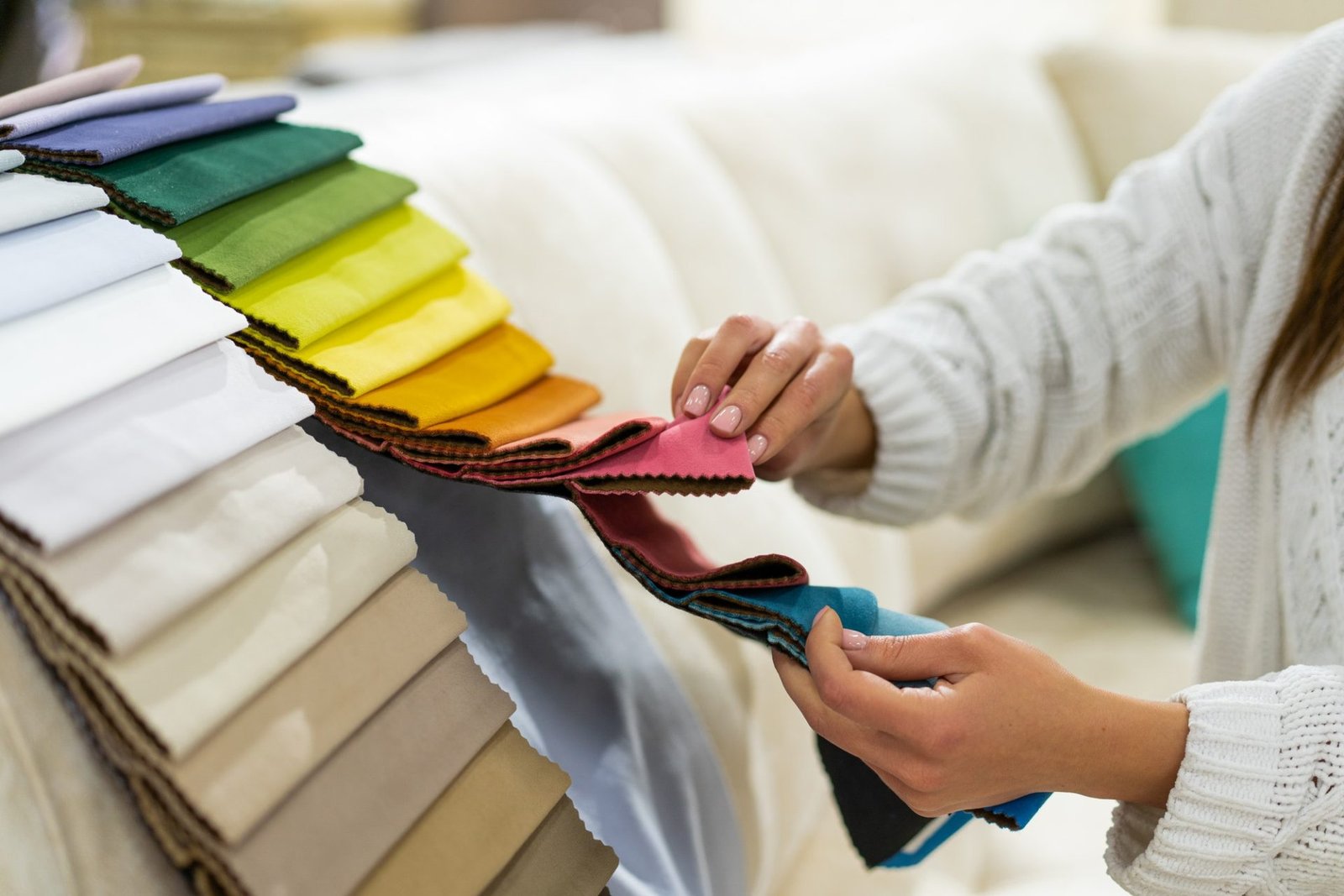 the-woman-chooses-the-fabric-on-the-sofa-textile-industry-background-tissue-catalog-e1627088629379